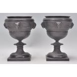A pair of 19th century Victorian cast spelter figural urns raised on socle plinth bases with rams
