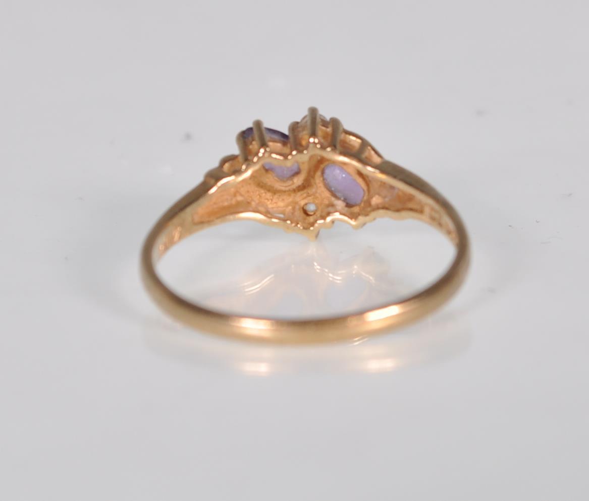 An English hallmarked 9ct yellow gold ladies dress ring set with two teardrop purple stones with two - Image 4 of 7