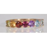 A 9ct yellow gold multi gem ladies dress ring set with amethyst, citrine, garnet, peridot, rhodolite