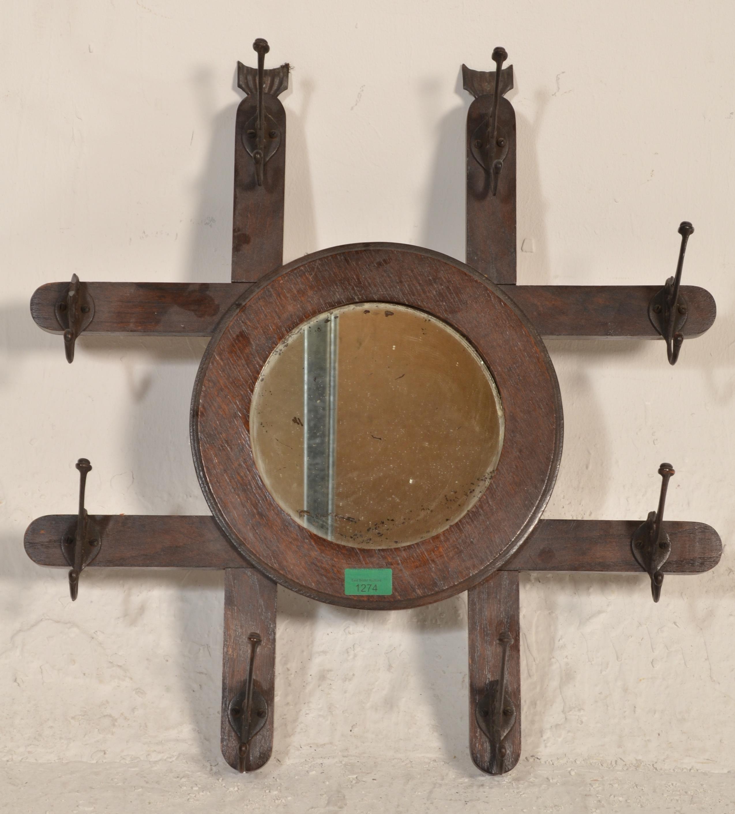 A late 19th century Victorian Arts & Crafts wall mirror coat rack combination. The roundel mirror on