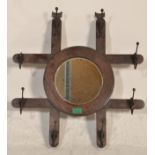 A late 19th century Victorian Arts & Crafts wall mirror coat rack combination. The roundel mirror on