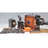 A collection of magic lantern slides and projectors to include two small projectors and one large