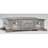 A 20th century Arts & Crafts pewter box in the manner of Archie Knox. Planished body with shaped top