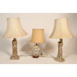 A pair of faux carved stone religious large table lamps, each with figural uprights complete with