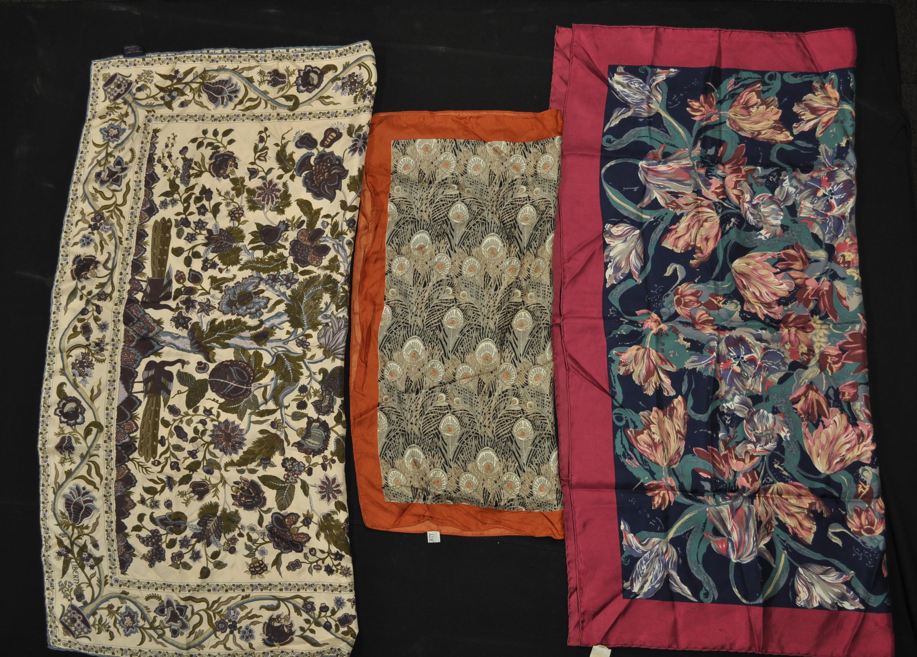 A group of three vintage Liberty printed silk scarves to include a blue floral print scarf, a