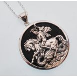 A sterling silver and onyx pendant necklace depicting St George slaying the dragon. Gross weight