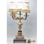 A 20th Century antique French style table lamp having four foliate scrolled arms with a central