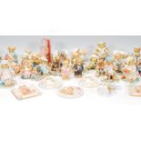 A large collection of Cherished Teddies of varying