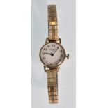 A hallmarked 9ct gold cased ladies wrist watch. The white enameled face having Arabic numeral