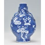 An antique 18th Century Chinese Kangxi prunus pattern moon flask vase in the typical prunus