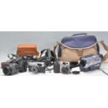 A mixed group of cameras of varying ages to include a Nikon D60 having a Nikon DX AF-S Nikkor 18-