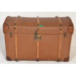 A vintage early 20th Century dome top canvas and cane bound steamer trunk having brass locks