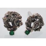 A pair of sterling silver cufflinks decorated with dragon and lions heads inset with jade style