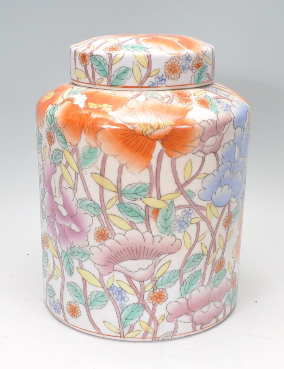 A large early 20th Century Chinese ginger jar of cylindrical form having hand painted floral sprays.