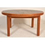 A retro mid century Danish teak wood and tile top circular coffee occasional table. Raised on square
