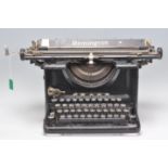 A vintage retro Remington sixteen typewriter having an ebonised body with ivory coloured