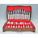 A vintage Webber & Hill silver plated cutlery canteen, each piece having scrolled design raised