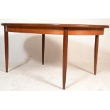 A retro 1970's G-Plan teak wood extending dining table raised on tapering supports with oval table