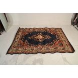 A large Persian / Islamic Kandahar floor rug with beige ground having geometric borders and