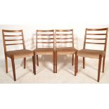A good set of four retro 20th Century teak framed rail back dining chairs having fabric seat pads