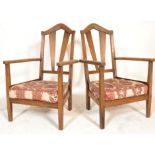 A pair of early 20th Century Cotswold School Arts and Crafts oak dining carver chairs / side