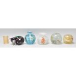 A group of paperweights to include a Mdina vase of bulbous form, a white speckled glass vase, two
