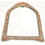 An unusual Moorish - Moroccan wall mirror having a stained camel bone panel piece cushion border