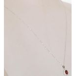 An 18ct white gold pendant pendant necklace having a fine link chain with a pendant set with a