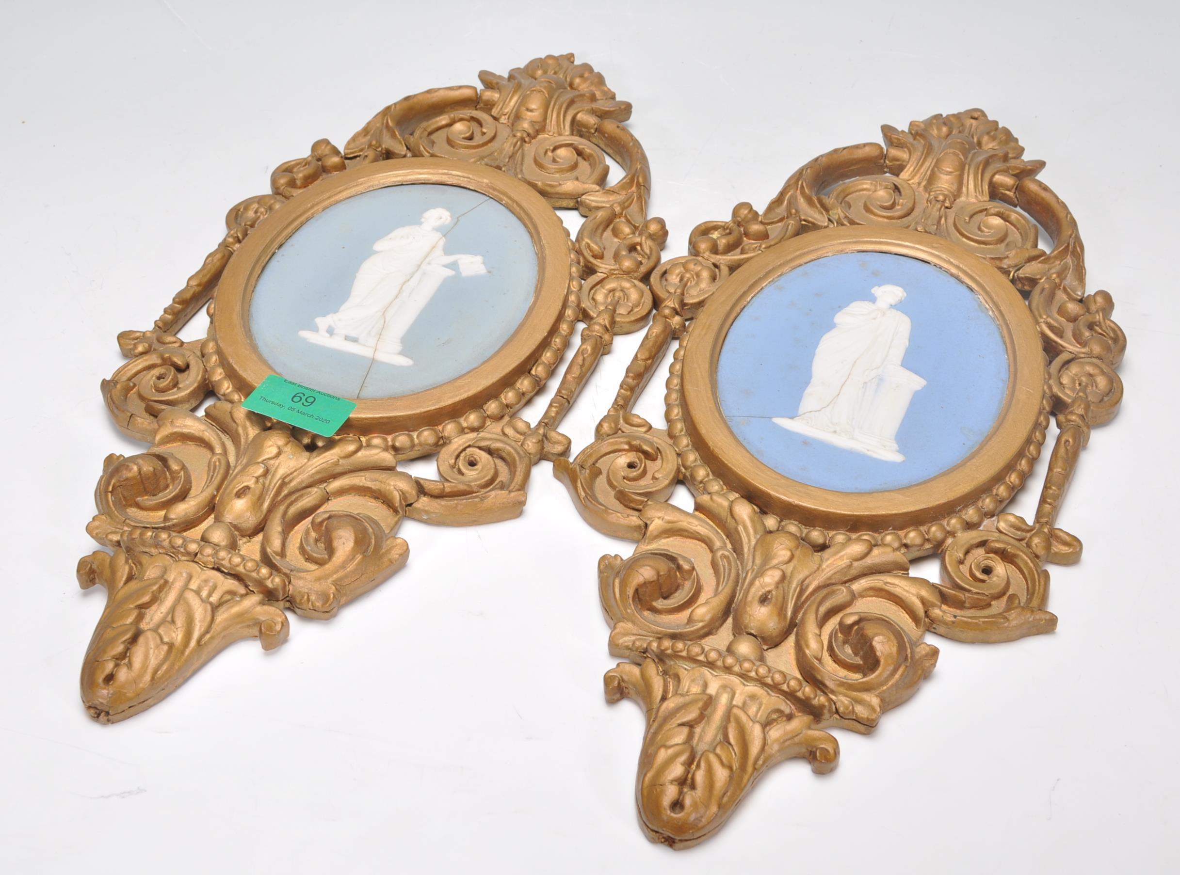 A pair of 19th century Wedgwood cameo plaques inset with classical scholars to each on oval blue