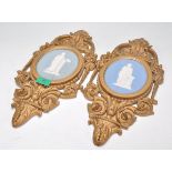 A pair of 19th century Wedgwood cameo plaques inset with classical scholars to each on oval blue