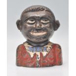 An original cast metal Jolly money bank with lettering to verso reading 'The Young Nigger Bank'.