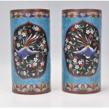 A pair of 19th century Chinese cloisonne vases. Each of cylindrical form with brass and wire