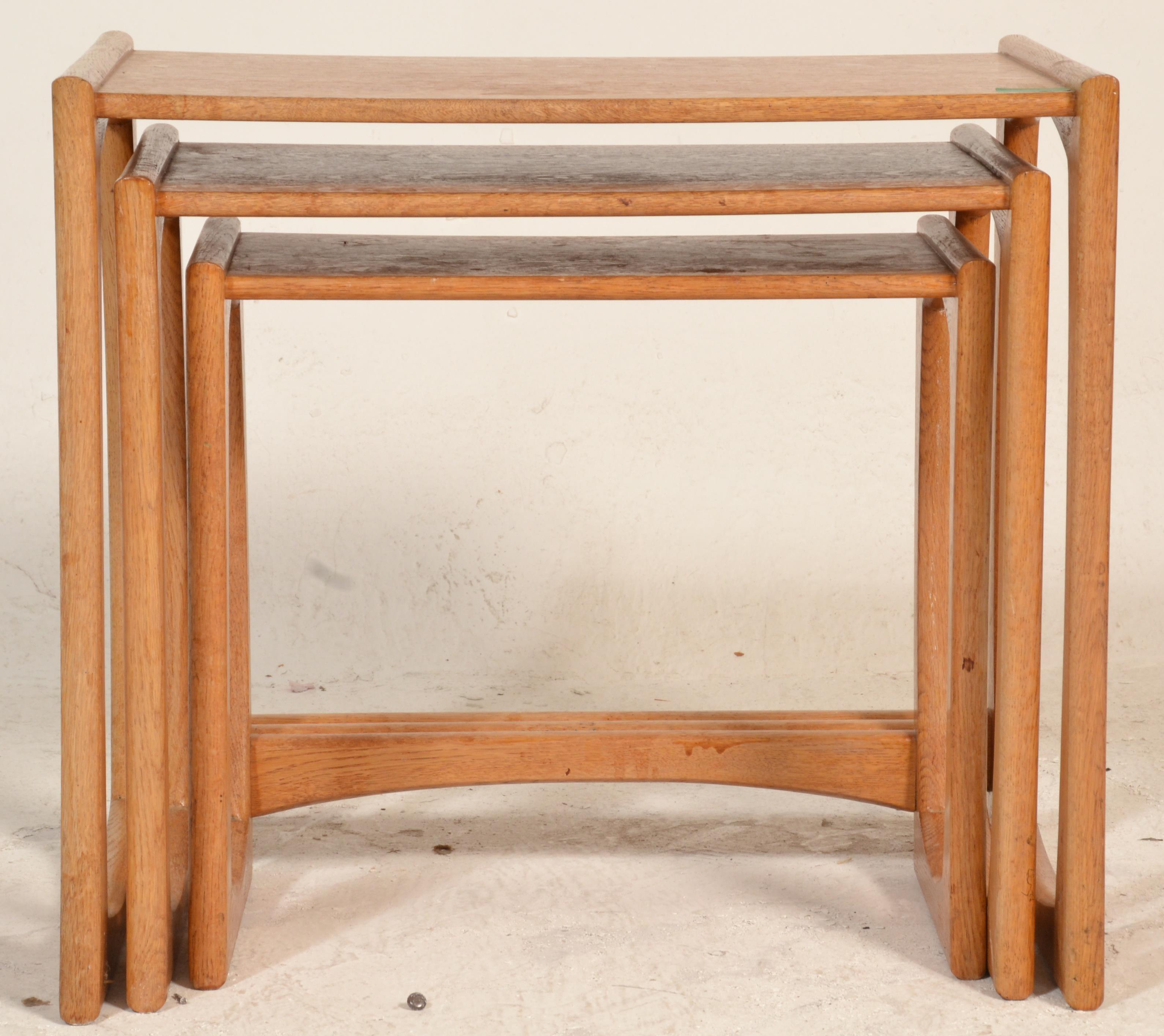 A 1970's G-Plan oak quadrille pattern nest of tables being raised on squared legs with shaped - Image 3 of 5