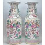 A pair of Chinese large 18th Century famille rose vases of baluster form having flared necks being