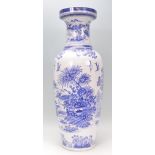 A large 20th century Chinese floor standing blue and white vase depicting fauna and birds with a