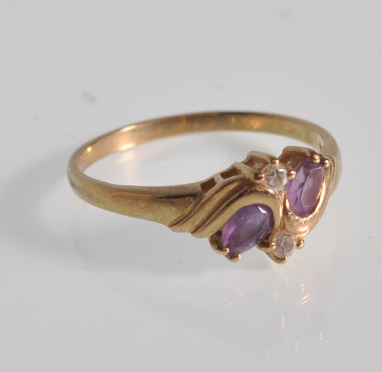 An English hallmarked 9ct yellow gold ladies dress ring set with two teardrop purple stones with two - Image 2 of 7