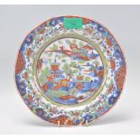 An 18th Century Chinese clobbered blue and white plate having hand painted blue and white pagoda and