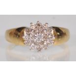 An 18ct yellow gold ladies diamond cluster ring having thick shoulders with approx 0.50pts.