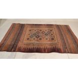 A 20th century Persian / Islamic floor ' Gabbeh '  rug with central red ground decorated with