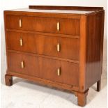 An early 20th Century Art Deco walnut chest of drawers consisting of three straight drawers having