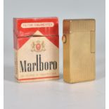 A vintage 20th Century Dunhill roller gas cigarette lighter of rectangular form having a gilt engine