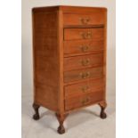 A 1930's Art Deco pedestal oak chest of drawers. Raised on claw and ball feet with cabriole legs