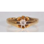 An 18ct yellow gold ladies ring set with a central faceted round cut white stone in a decorative