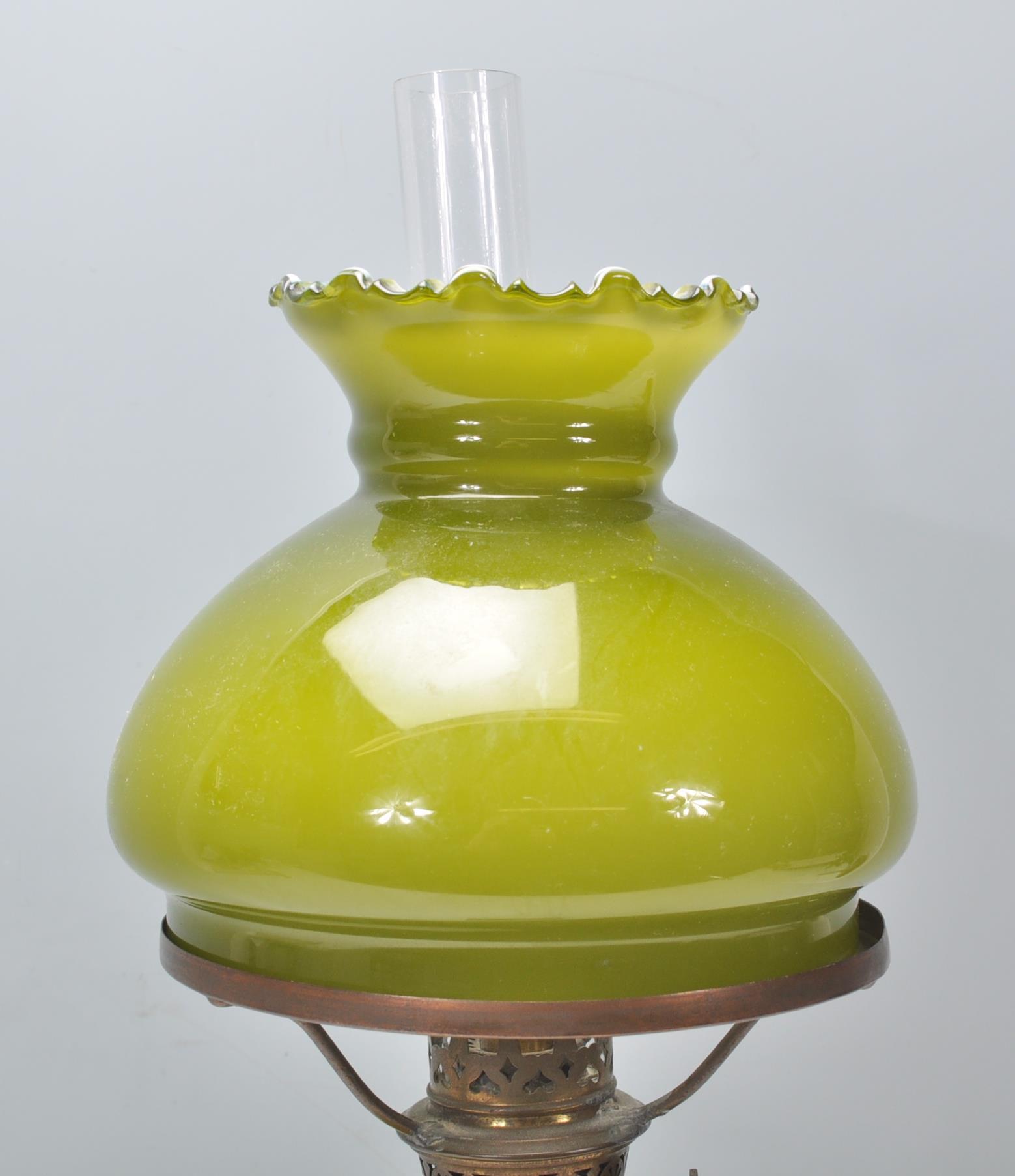 A 19th Century Victorian oil lamp of small proportions being raised on a square stepped base - Image 5 of 6