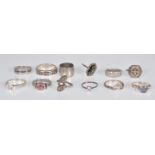 A group of 12 silver rings to include an Art Deco panel ring set with marcasites, a twist design