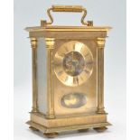 A vintage 20th Century 8 day carriage clock being brass cased with three sides set with glazed
