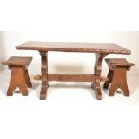 A large heavy 20th century chunky oak refectory dining table and 2 stools / chairs. The heavy