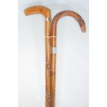 A pair of 20th century wooden walking sticks havin