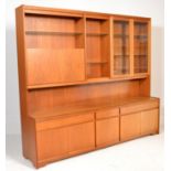 A mid century large upright teak wood dresser cabinet sideboard combination with a base of cupboards