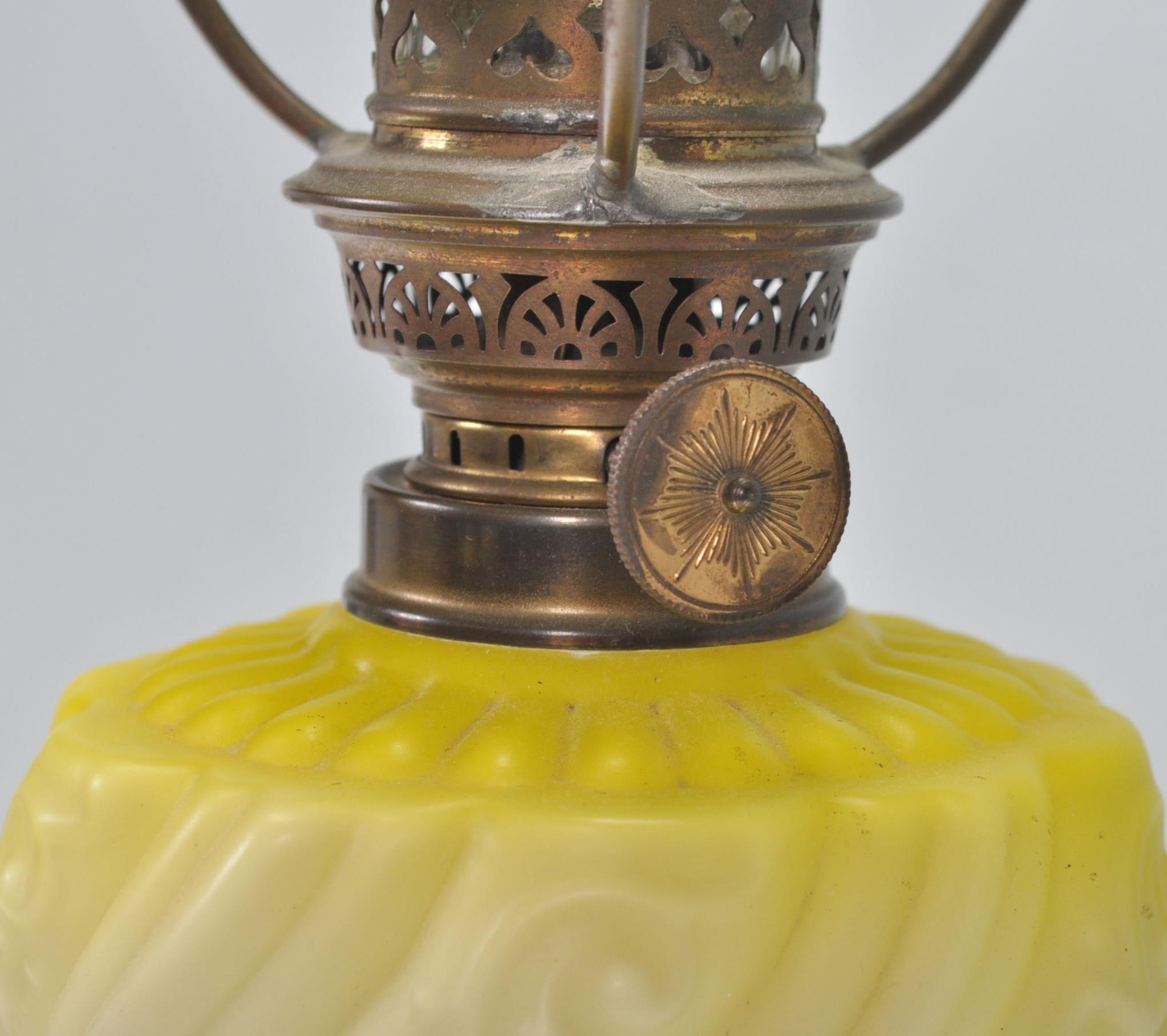 A 19th Century Victorian oil lamp of small proportions being raised on a square stepped base - Image 6 of 6